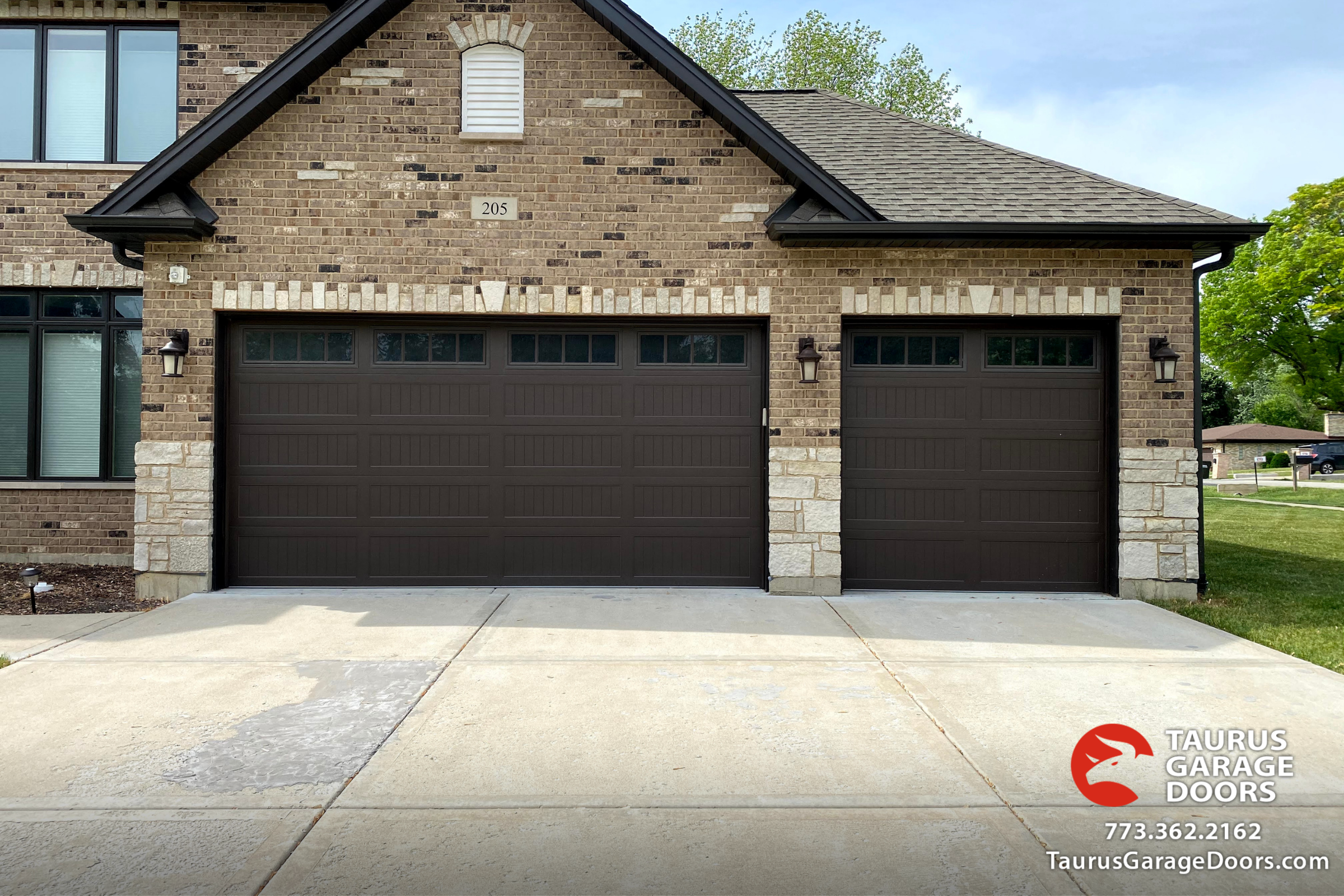 carriage-style-garage-door-in-brown-color-with-decorative-windows