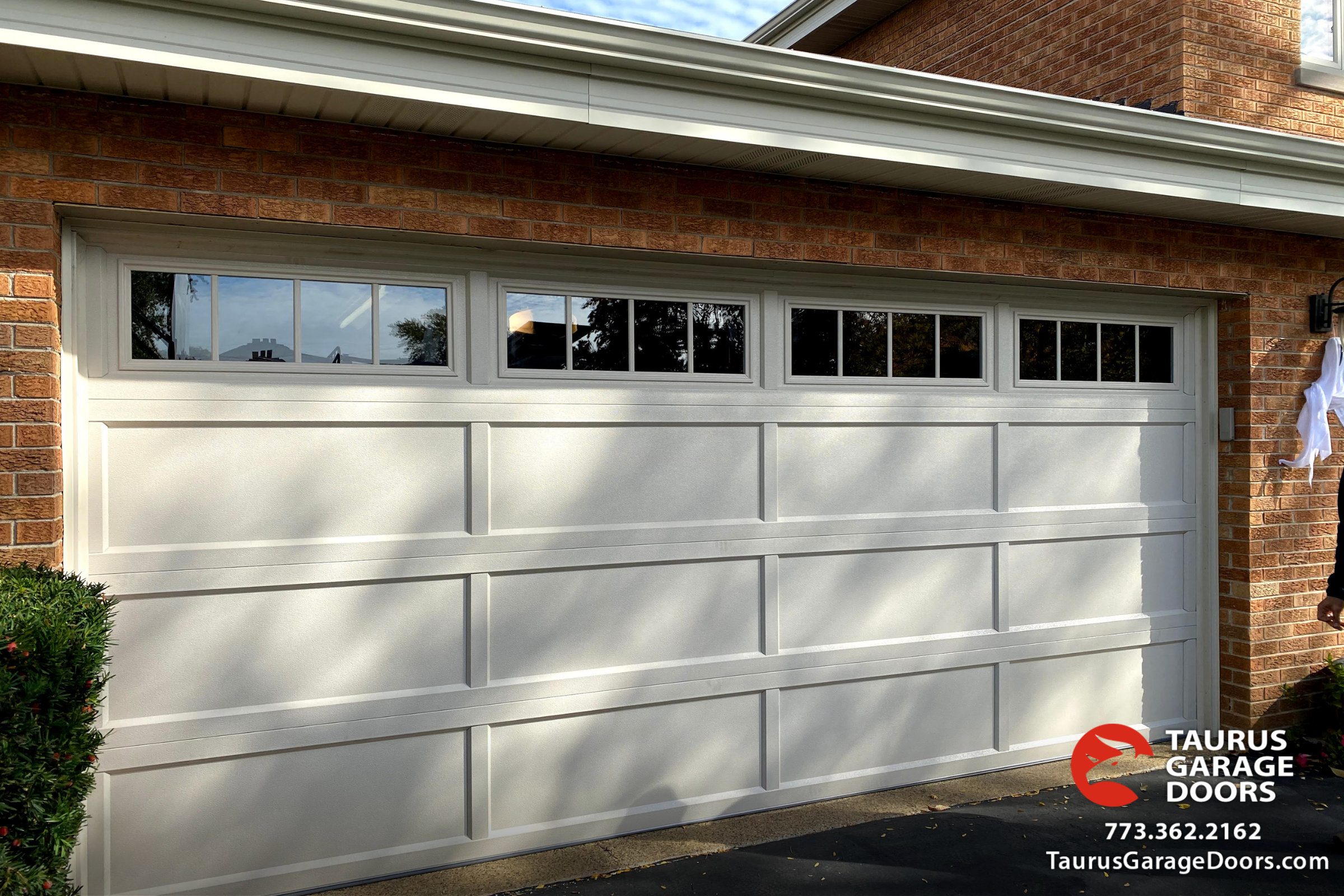 steel-garage-door-recessed-panel-in-almond-color-with-windows